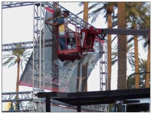 Outdoor Mesh Banner Being Installed on Truss Display